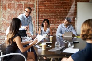 Businesspeople,Meeting,In,Modern,Boardroom,Through,Glass